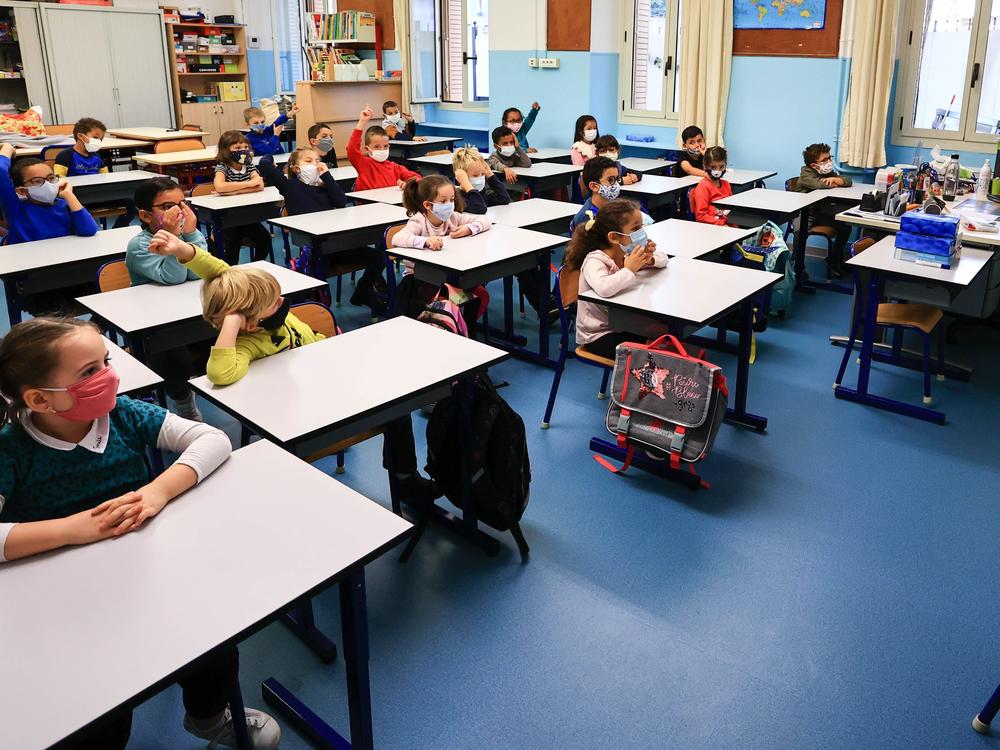 Students attend class wearing face masks in Antibes, France, on Nov. 2. At the end of October, France returned to a partial national lockdown to stem a surge in coronavirus cases. Meanwhile, schools remain open.