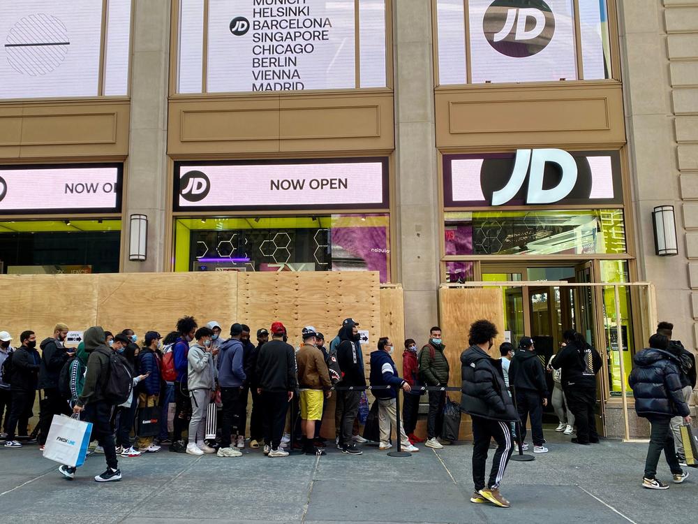 People wait in line outside for their turn to enter the JD Sports store in New York City on Nov. 5.