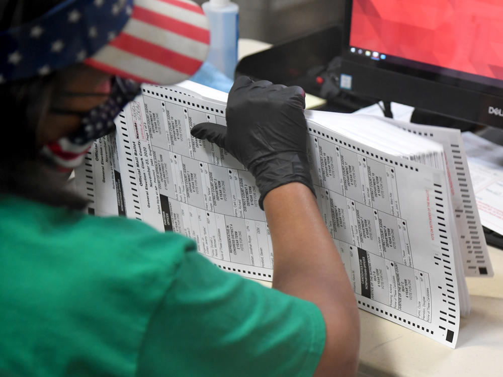 A Clark County election worker scans mail-in ballots on Nov. 7 in North Las Vegas, Nevada.