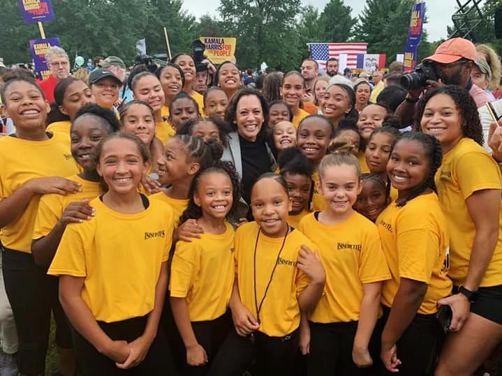 Kamala Harris poses with the Isiserettes, a legendary drill-and-drum team, at the Polk County Steak Fry in Iowa in 2019.