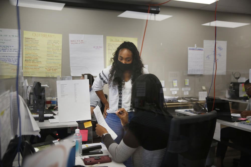 Emily Williams, a senior at the University of Illinois who's studying community health, confers with a supervisor on a case.