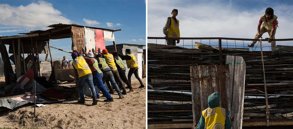 Contract workers hired by the authorities tear down a settlement.
