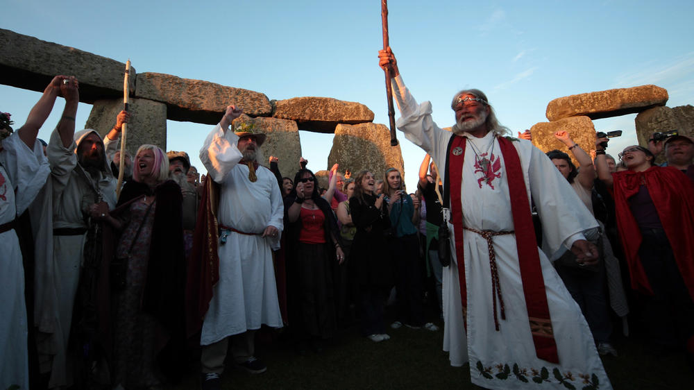 Druid King Arthur Pendragon, conducts a Solstice sunset service as people gather in the megalithic monument of Stonehenge in 2010.