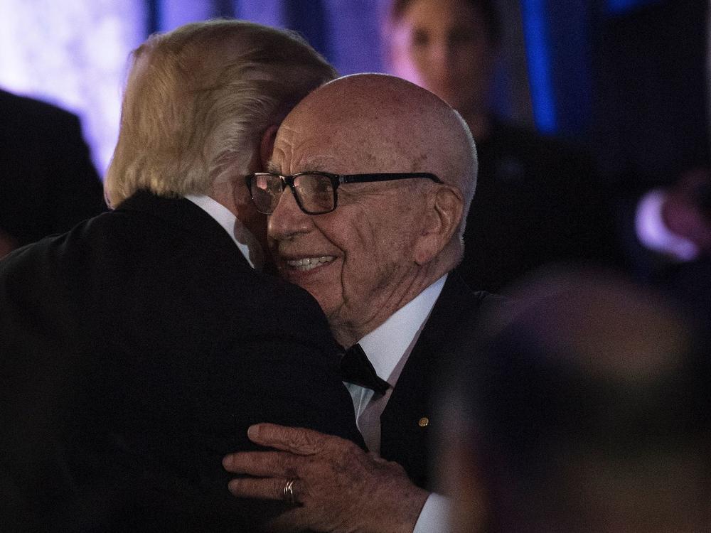 President Trump embraces Rupert Murdoch, co-chairman of Fox Corp., at a dinner in 2017. Once close, Trump is now angry at Murdoch's Fox News over its election coverage.