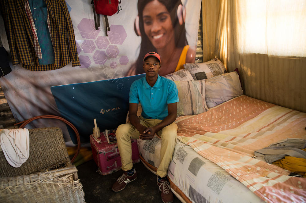 As people settle into their shacks in Covid, they start to unpack small comforts that make a place feel like home. Sivuyile Duma put up photos of his brothers and friends. 