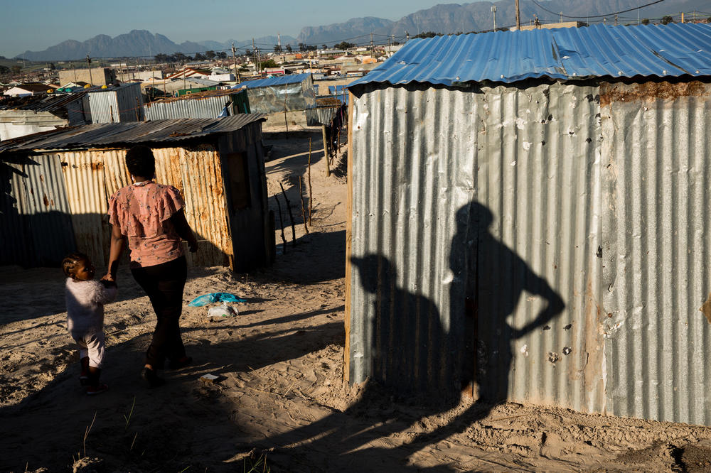 A woman and her daughter walk through the streets of Covid.