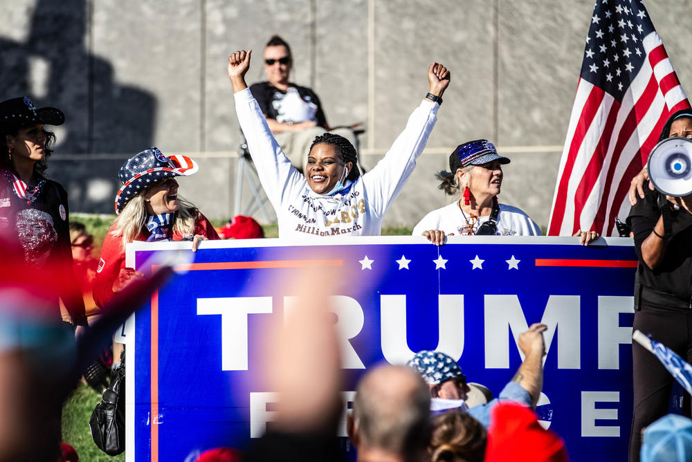 A marcher shows her support for Trump.
