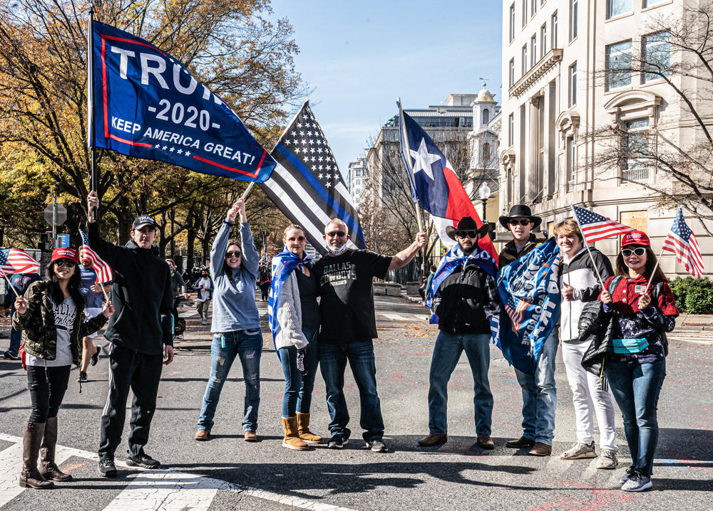 Trump supporters raise their flags at the Million MAGA March.