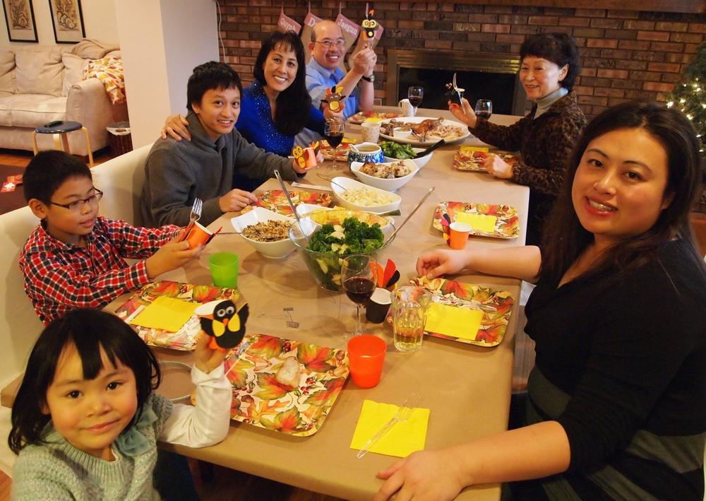 Linh Song (lower right) and Tina Lam (upper right) celebrate a family Thanksgiving in Ann Arbor, Mich, in 2014.