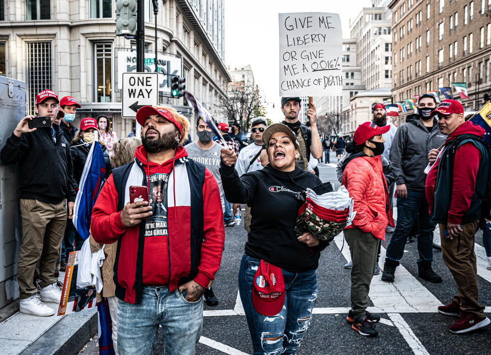 Trump Supporters argue with counterprotesters behind the police line.