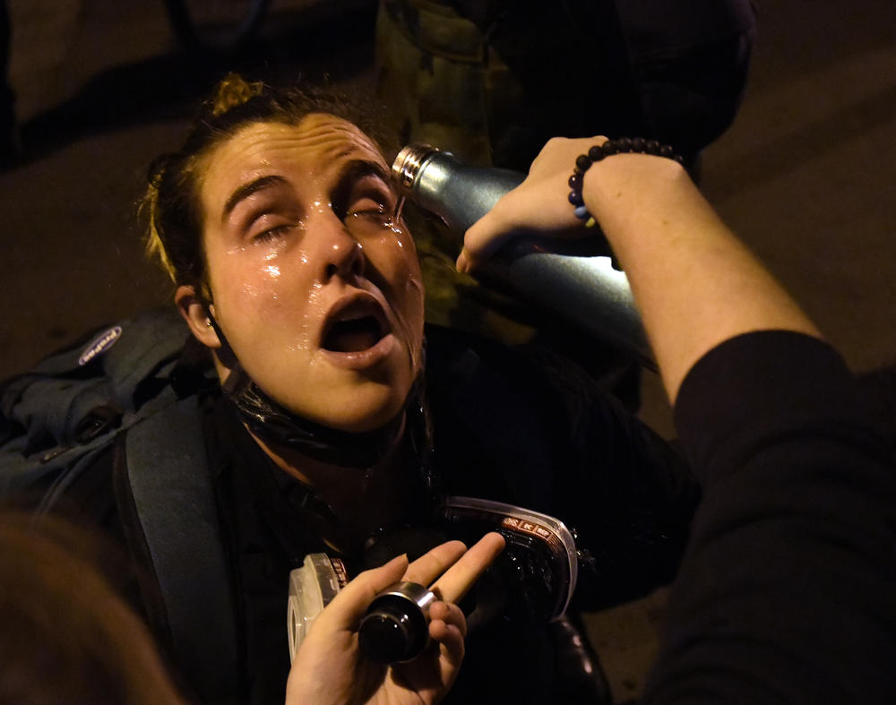 A protester gets her eyes flushed after clashes broke out on Black Lives Matter Plaza.