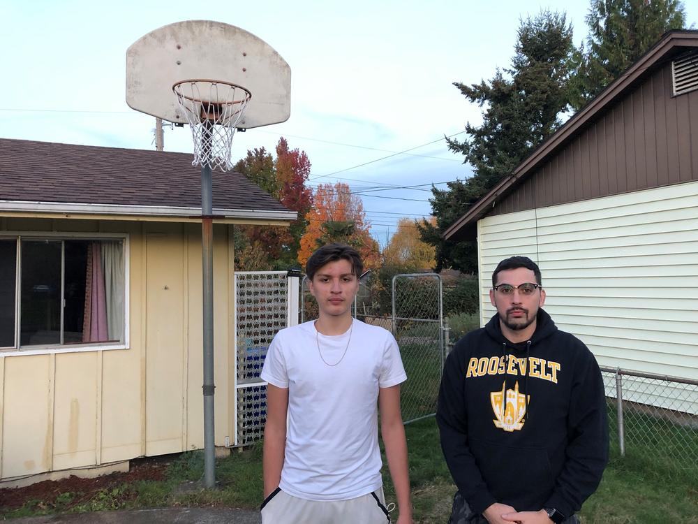 Antonio Jimenez (L) and his father Antonio Garcia at their home in Portland, Ore. Jimenez, a 16-year-old high school junior, has been trying to develop his basketball skills during the pandemic by training in small groups with other players and shooting several hundred jump shots daily at home.