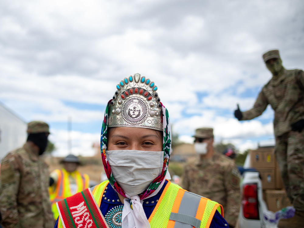 Miss Navajo Nation Shaandiin P. Parrish puts on a white gown to help distribute food, water, and other supplies to Navajo families on May 27, 2020 in Huerfano on the Navajo Nation Reservation, New Mexico.