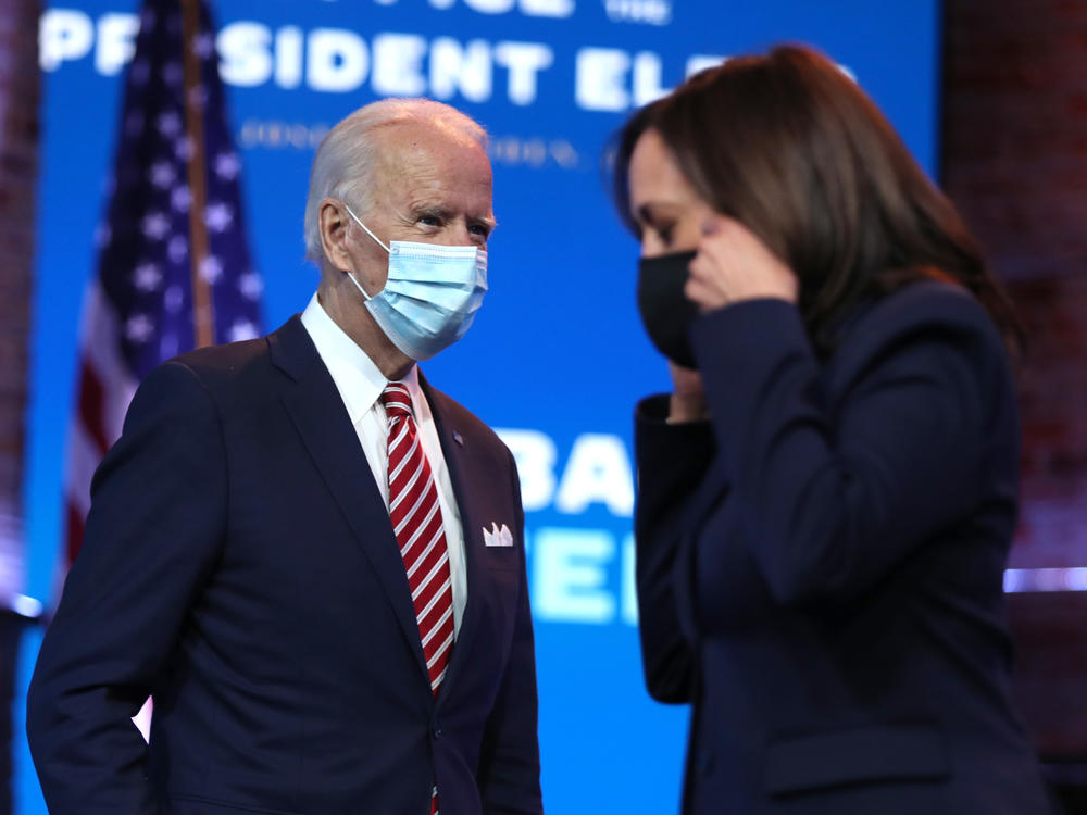 President-elect Joe Biden walks by Vice President-elect Kamala Harris before delivering remarks on his plan for economic recovery under his incoming administration.