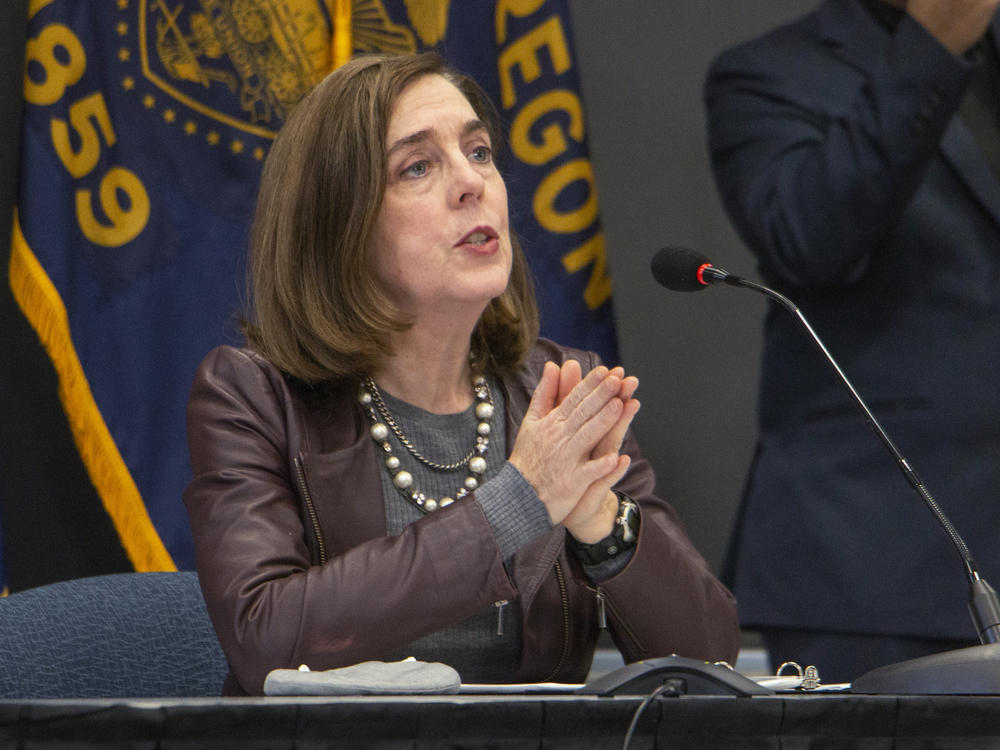 Oregon Gov. Kate Brown (shown here on Nov. 10) has ordered new statewide restrictions to head off a resurgence in coronavirus cases.