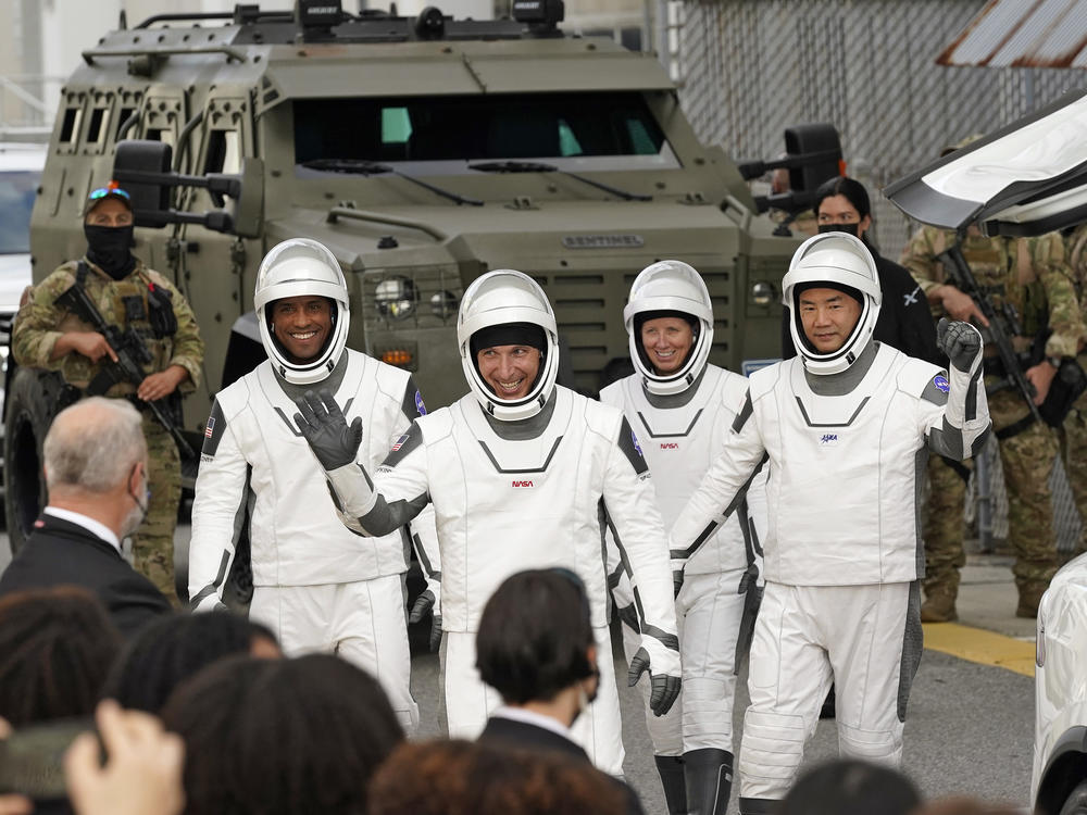 Astronauts (from left) Victor Glover, Michael Hopkins, Shannon Walker and Japan's Soichi Noguchi wave to family and friends as they leave for the launch site on Sunday.