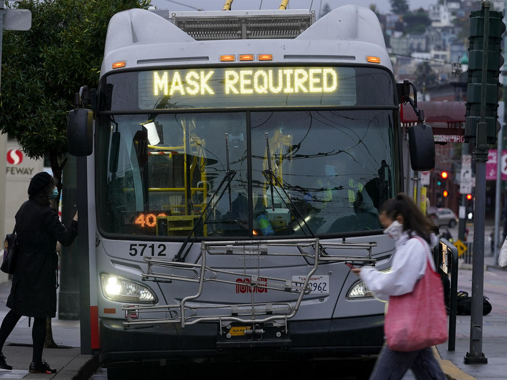 A sign on a San Francisco bus advises that passengers are required to wear masks. Health officials have renewed pleas for Americans to protect themselves and others from the coronavirus as the death toll passes 250,000.