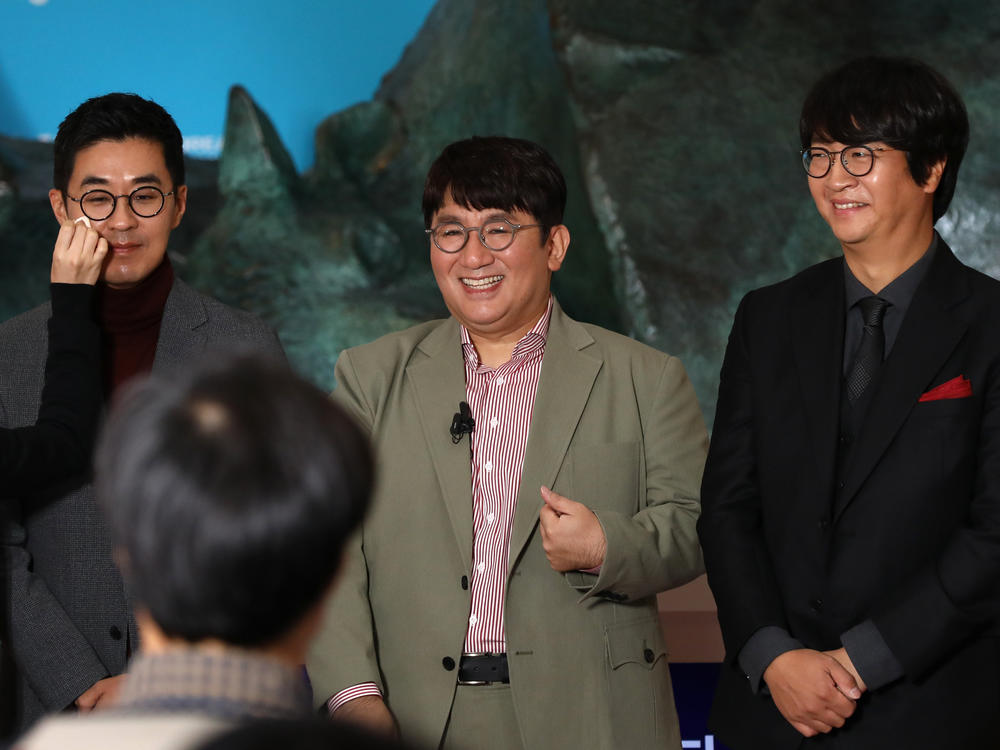 Chairman and CEO Bang Si-hyuk, center, photographed Oct. 15, 2020, the day his company, Big Hit Entertainment, debuted on the Korea Exchange in Seoul. To his left, Jiwon Park, Big Hit CEO of HQ & Management; right, Lenzo Yoon Big CEO of Global & Business.