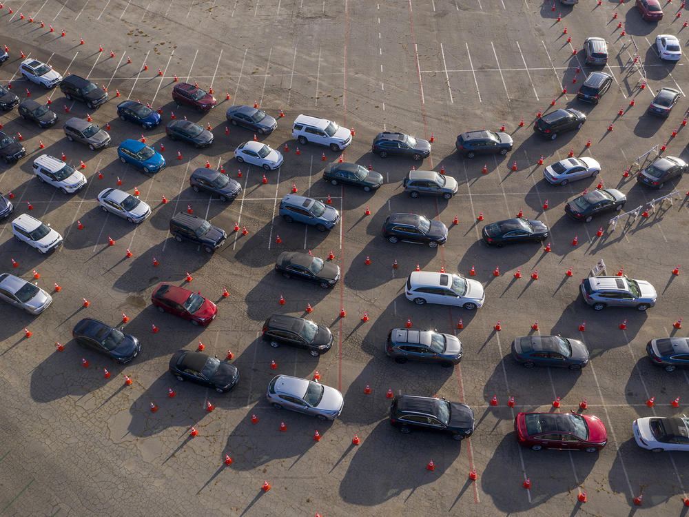 In an aerial view from a drone, cars line up at Dodger Stadium for COVID-19 testing in Los Angeles, California.