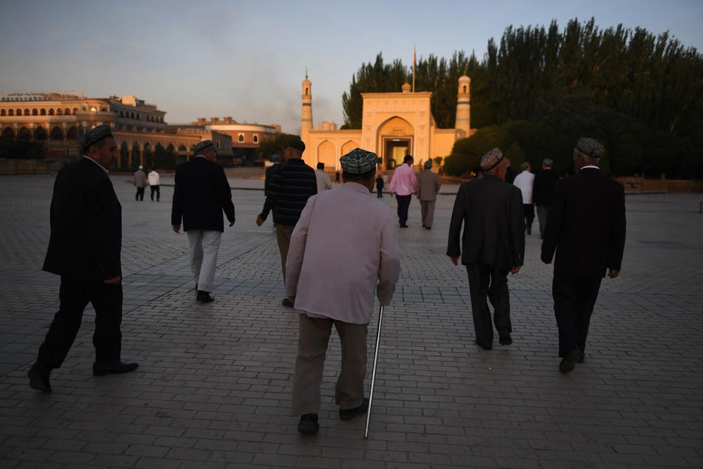 Uighur men walk towards the Id Kah mosque to attend prayers marking the end of Ramadan, in Kashgar in China's northwest Xinjiang region, in 2019.
