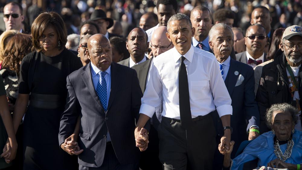 Obama and Rep. John Lewis walk across across the Edmund Pettus Bridge to mark the 50th anniversary of the Selma to Montgomery civil rights marches in Selma, Ala.