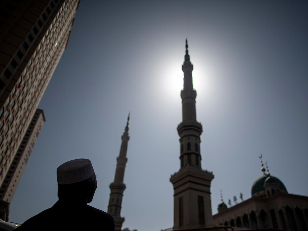 An ethnic Hui Muslim man stands in front of Laohuasi Mosque in Linxia, Gansu province, in 2018. Chinese Muslims are most densely clustered in the northwestern regions of Gansu, Ningxia and Xinjiang, but live across the country, as they have for more than a millennium.