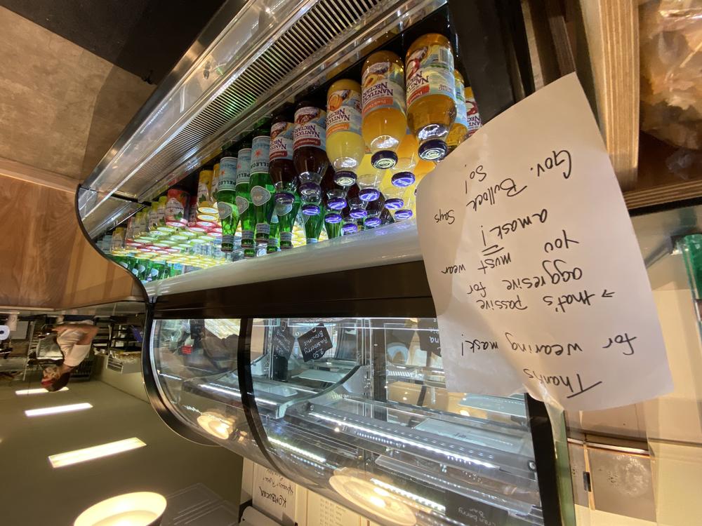 A sign at a coffee shop reminds customers that masks are required by Montana's governor. The mandate, shop owners say, helps limit confrontations.