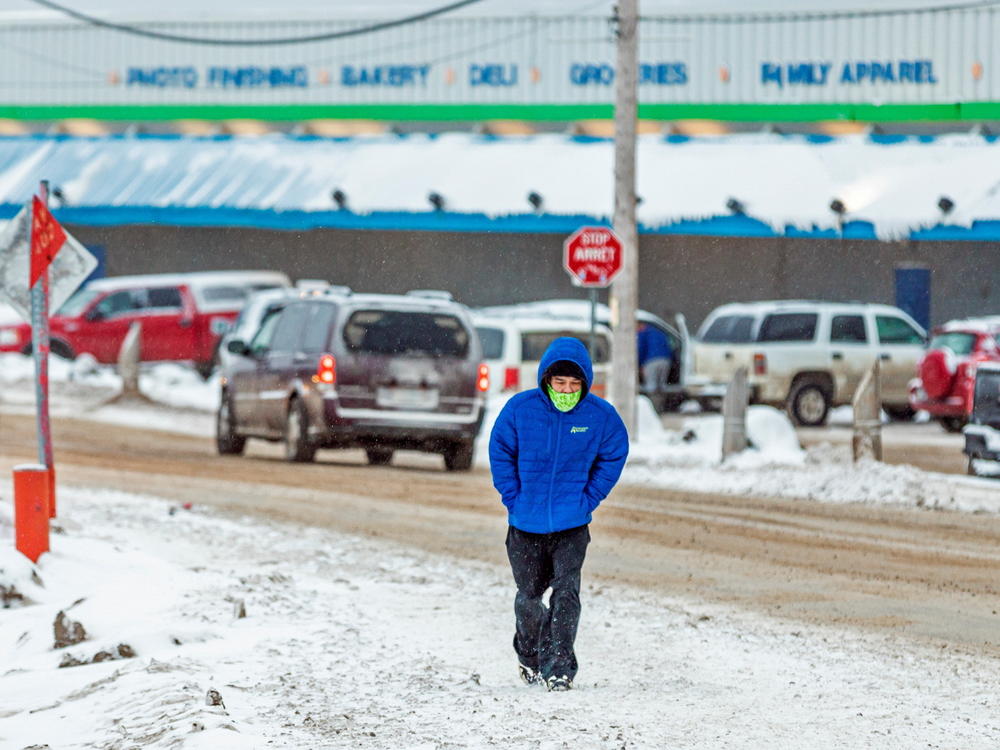 A man wears a mask as the territory of Nunavut enters a two week mandatory restriction period in Iqaluit, Nunavut, Canada, on Wednesday. More than 80 COVID-19 cases have been identified this month in Nunavut, where around 39,000 people, predominantly Inuit, live in communities scattered across the territory.