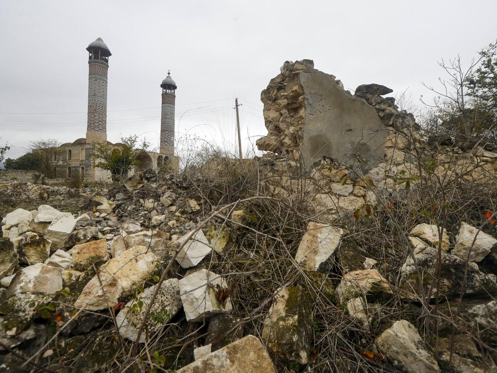 A mosque is seen through ruins in Aghdam on Thursday, just before the formal entry of Azerbaijani forces. As part of a recent peace agreement, Armenia ceded control of several regions in and around the disputed territory of Nagorno-Karabakh.