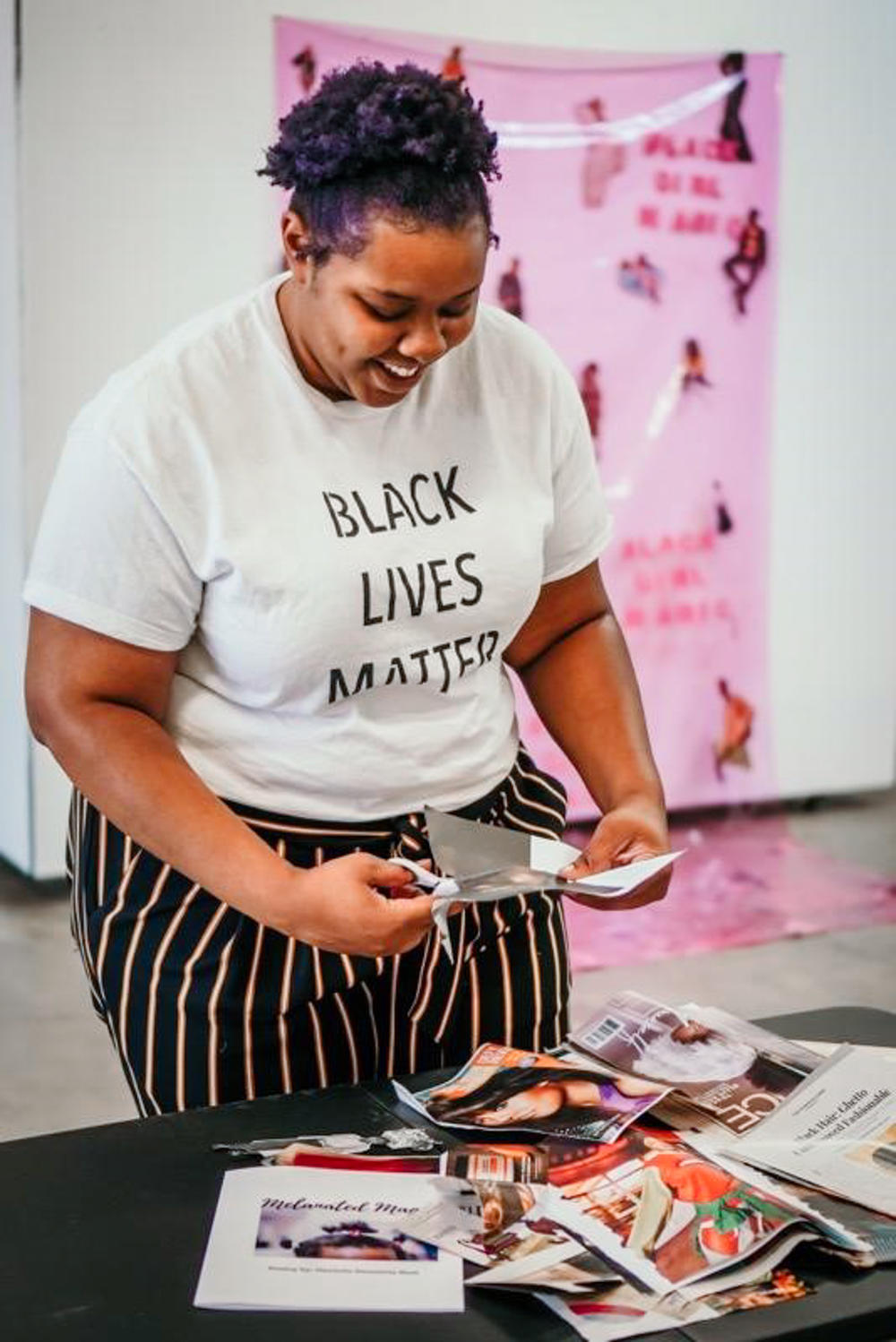 Danielle Demetria East cuts magazines for a collage in her studio in Lubbock, Texas.