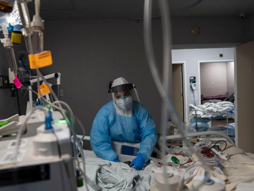 A health care worker treats a COVID-19 patient at the ICU at United Memorial Medical Center in Houston. Twenty-two percent of hospitals in Texas reported critical staffing shortages this week in new federal data.