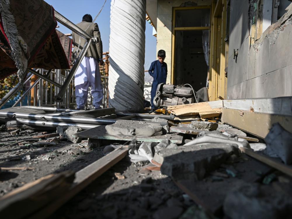 Residents inspect a damaged house after several rockets landed Saturday in Afghanistan's capital, Kabul. The Islamic State claimed responsibility for the attack, which comes the same day as U.S. Secretary of State Mike Pompeo's meeting with Taliban leaders in Qatar.
