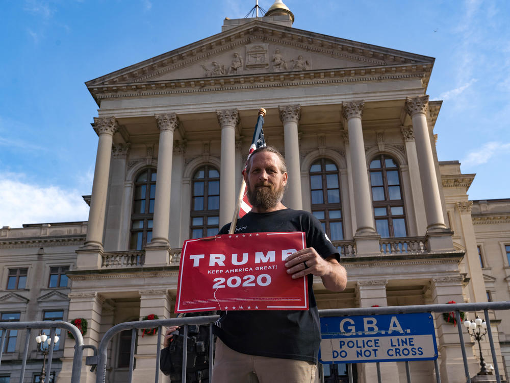 A supporter of President Trump protests outside the Georgia State Capitol on Saturday in Atlanta. The president's campaign has requested a vote recount in the state.