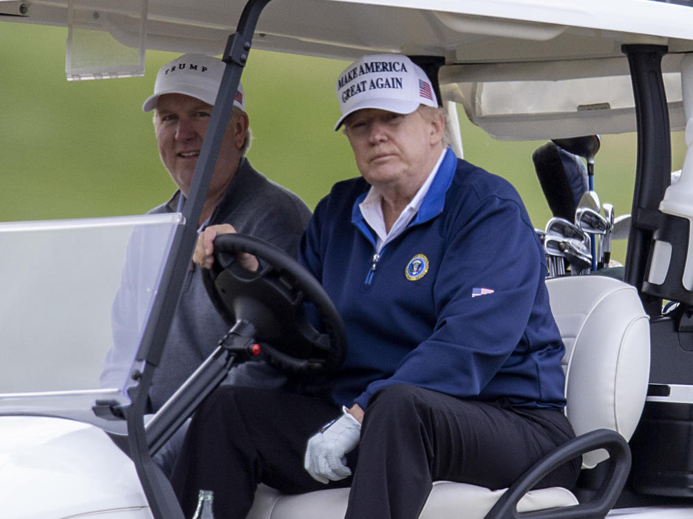 President Trump drives a golf cart Sunday at Trump National Golf Club in Sterling, Va.