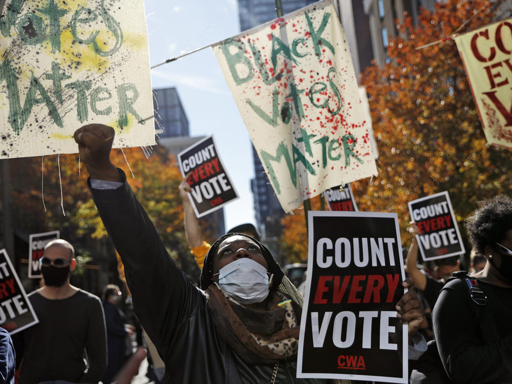 Zhanon Morales, 30, of Philadelphia raises a fist during a Nov. 5 voting rights rally. President Trump's campaign unsuccessfully used spurious claims of voter fraud to invalidate votes in Philadelphia and other largely Black cities.