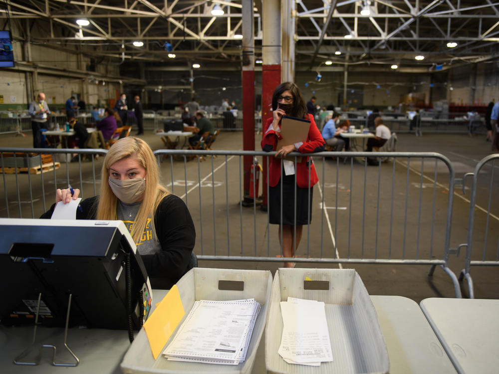 A poll watcher monitors the counting of ballots at the Allegheny County elections warehouse on Nov. 6 in Pittsburgh.