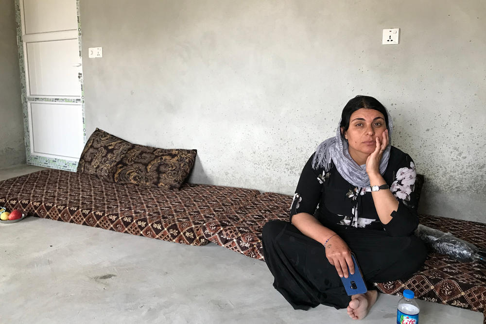 Kamo Zandinan sits in a friend's home in a village in Sinjar in northern Iraq. She believes an older daughter is alive and still in Iraq. The girl was 13 when she was taken by ISIS. 