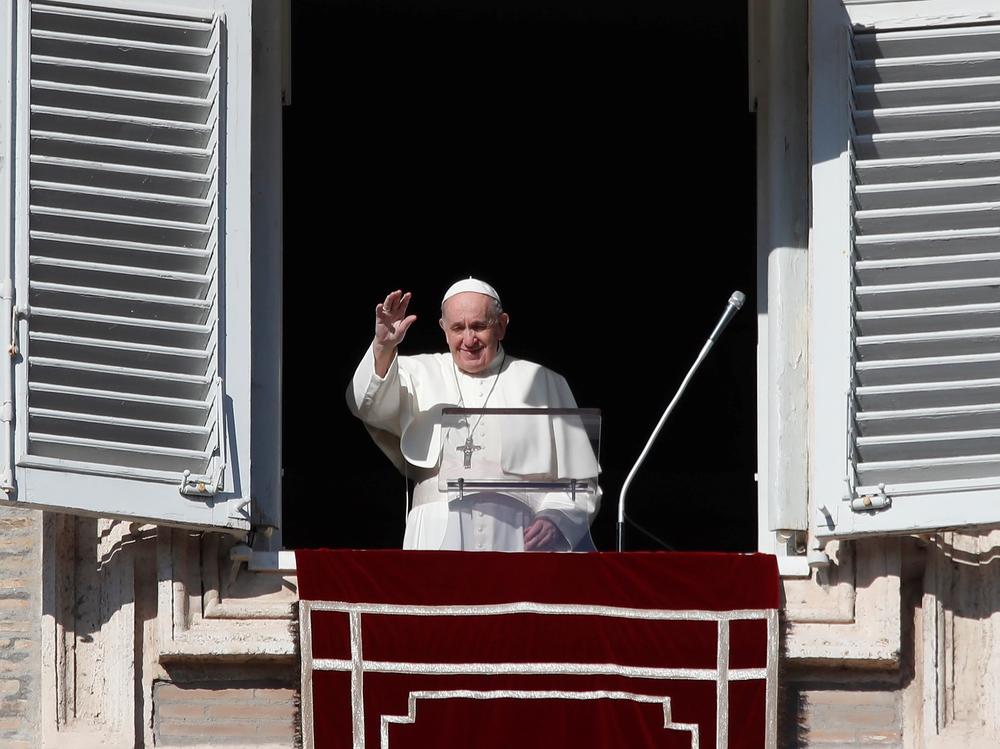 Pope Francis arrives at the window of his studio for the Angelus noon prayer in St. Peter's Square at the Vatican, Sunday.