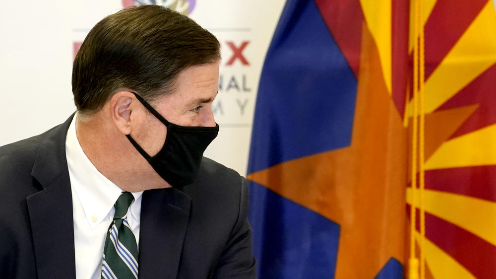 Arizona Gov. Doug Ducey listens during a roundtable discussion last month in Phoenix. 