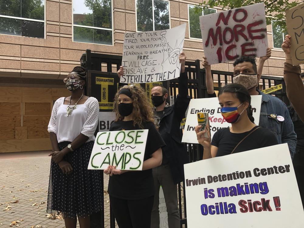 Protesters gather for a news conference in Atlanta earlier this year, shortly after the release of a complaint by whistleblower Dawn Wooten, a nurse at Irwin County Detention Center in Ocilla, Ga.
