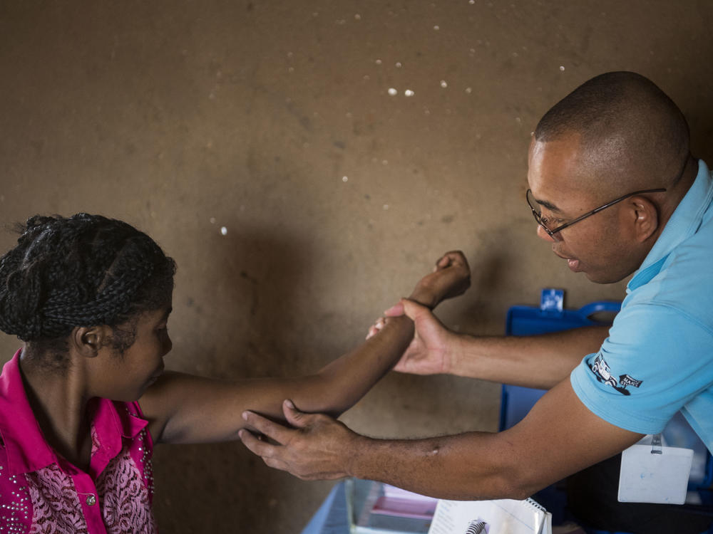 Nana (left) gets her birth control implant checked by Dr. Jean Rangomana during the Marie Stopes International mobile clinic in Besakoa, Madagascar, on April 9, 2018. Abortion is illegal under all circumstances in Madagascar, and Trump administration policies led to shortages of birth control there, health workers say.