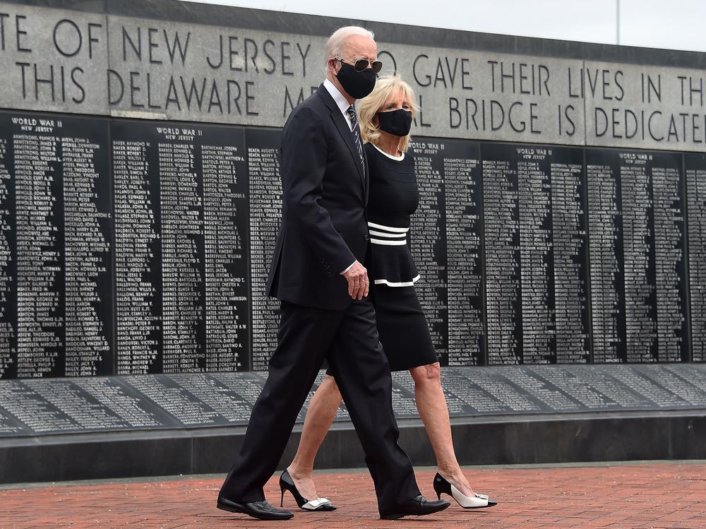 Joe Biden and his wife, Jill Biden, wear masks as they mark Memorial Day. The president-elect has consistently worn masks amid the pandemic, and he's already talking to governors about trying to implement a national mask mandate.