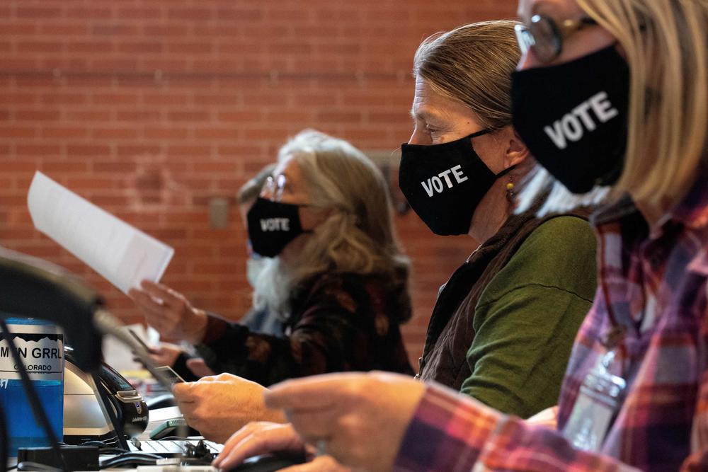 Poll workers prepare ballots on Election Day at the Nederland Community Center in Nederland, Colo.