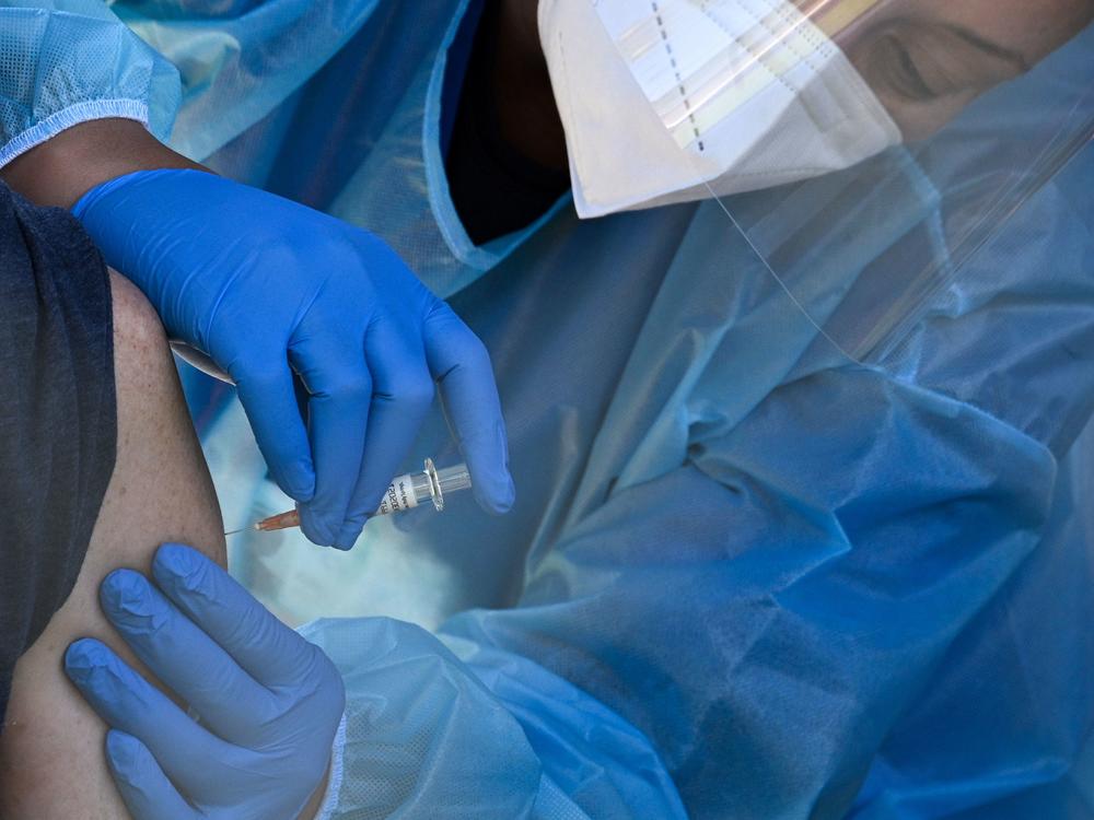 A flu vaccine is administered at a walk-up COVID-19 testing site, in San Fernando, Calif. Emergency use authorization is expected soon for vaccines for COVID-19.