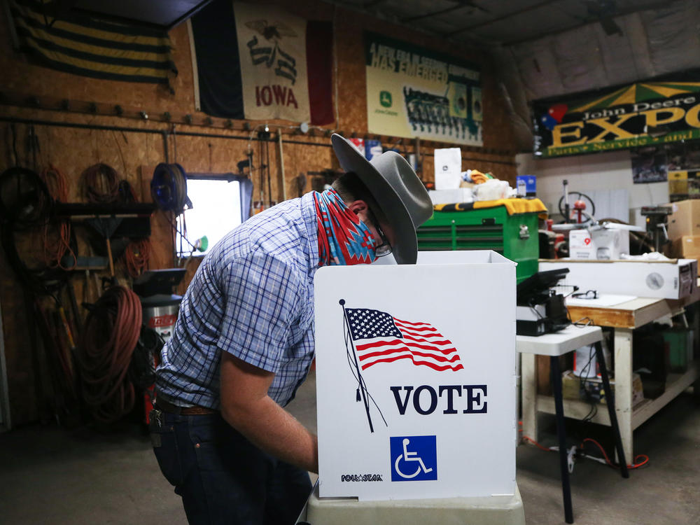 A voter marks his ballot at a polling place on Election Day in Richland, Iowa.