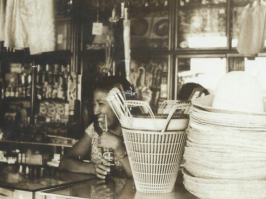 A young Crescenciana Tan working as cashier at a local grocery store in the Philippines in 1960.