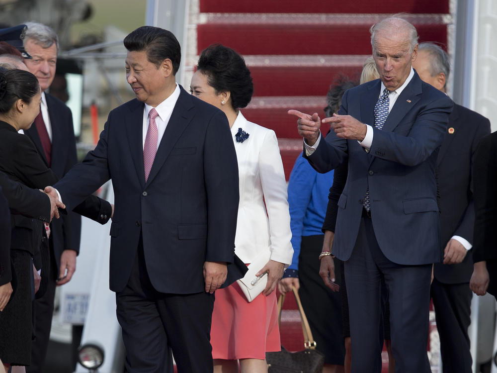 Then-Vice President Joe Biden gestures toward Chinese President Xi Jinping and his wife Peng Liyuan during an arrival ceremony in Andrews Air Force Base, Md., Sept. 24, 2015.