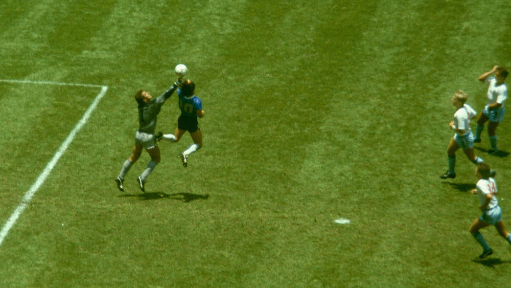 Maradona outjumps England goalkeeper Peter Shilton to score with his 'Hand of God' goal as England defenders look on during the 1986 FIFA World Cup Quarter Final in Mexico City.