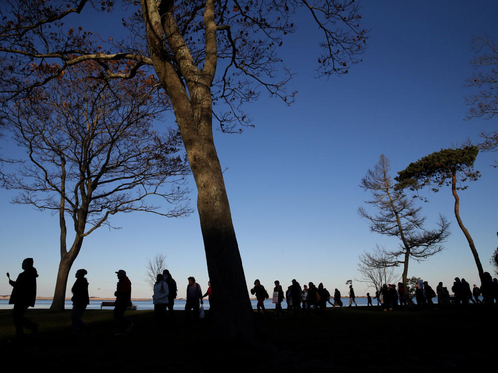 Marchers perform a Stomp Dance in Pilgrim Memorial State Park during the 48th National Day of Mourning in Plymouth, Mass., on Nov 23, 2017. Since 1970, Indigenous people have gathered at noon on Cole's Hill in Plymouth to commemorate a National Day of Mourning on Thanksgiving.