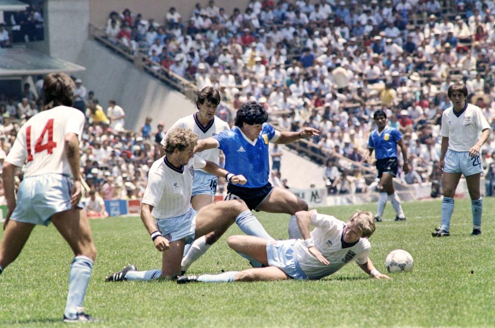 Maradona, center, dribbles past three English defenders during the World Cup quarterfinal soccer match in Mexico City, 1986.